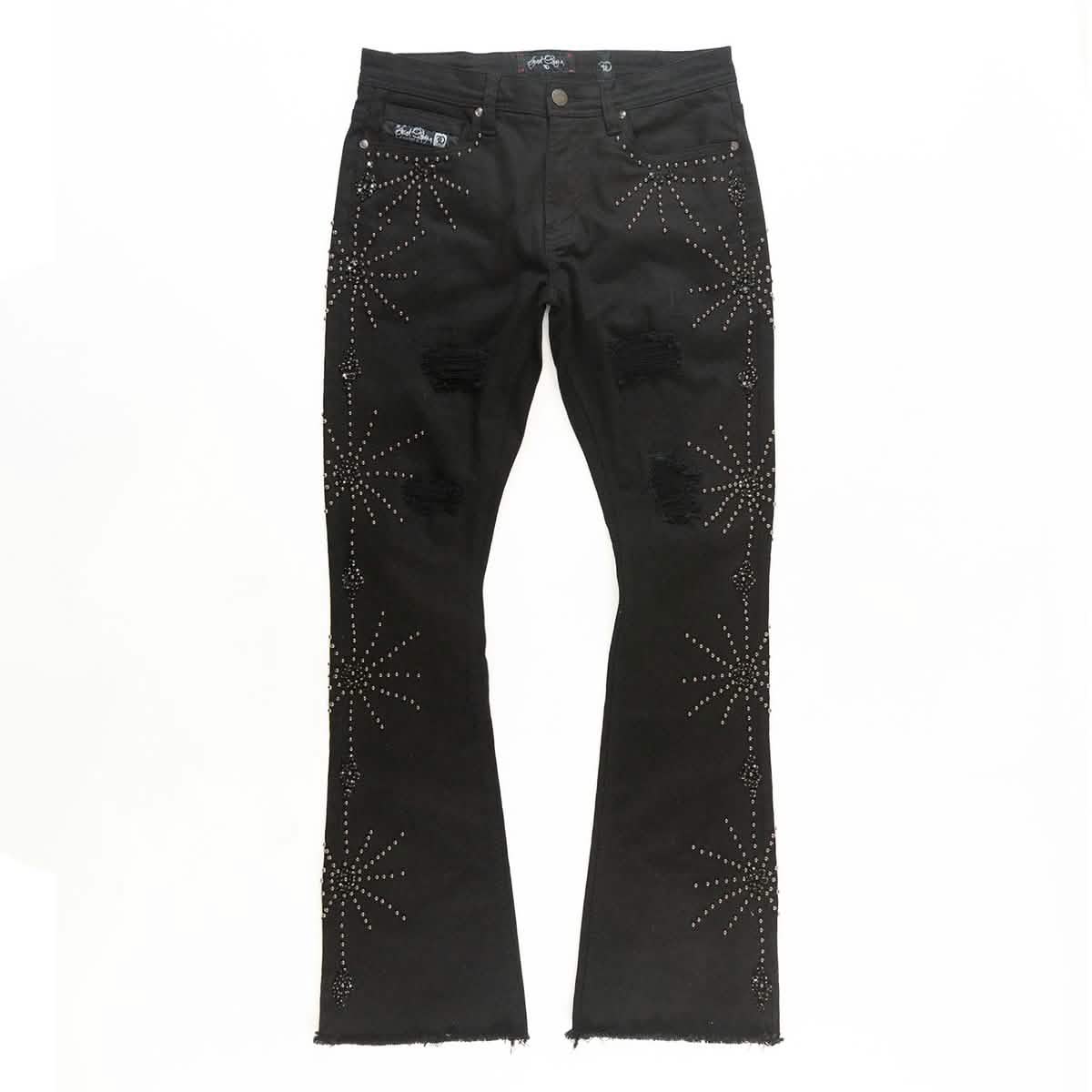 Black jeans with rhinestone spider web embellishments on a white background
