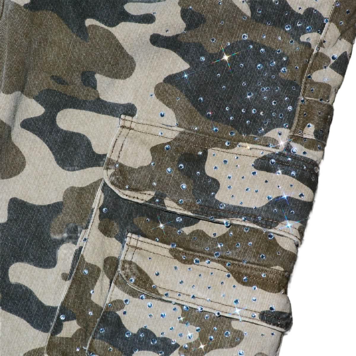 Camouflage shorts with rhinestone embellishments on a neutral background