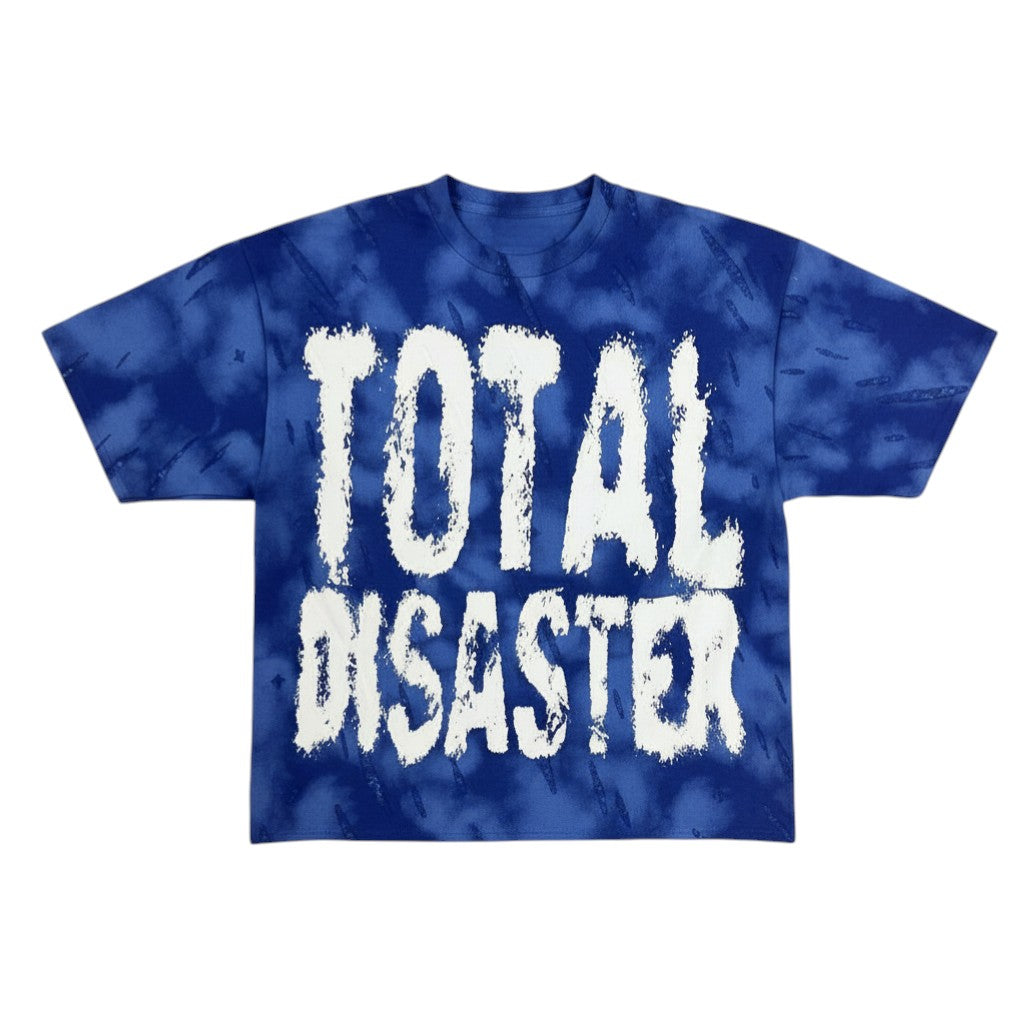 On Time Fashions Saint Cropped Tee, a blue tie-dye t-shirt with white "TOTAL DISASTER" graphic.