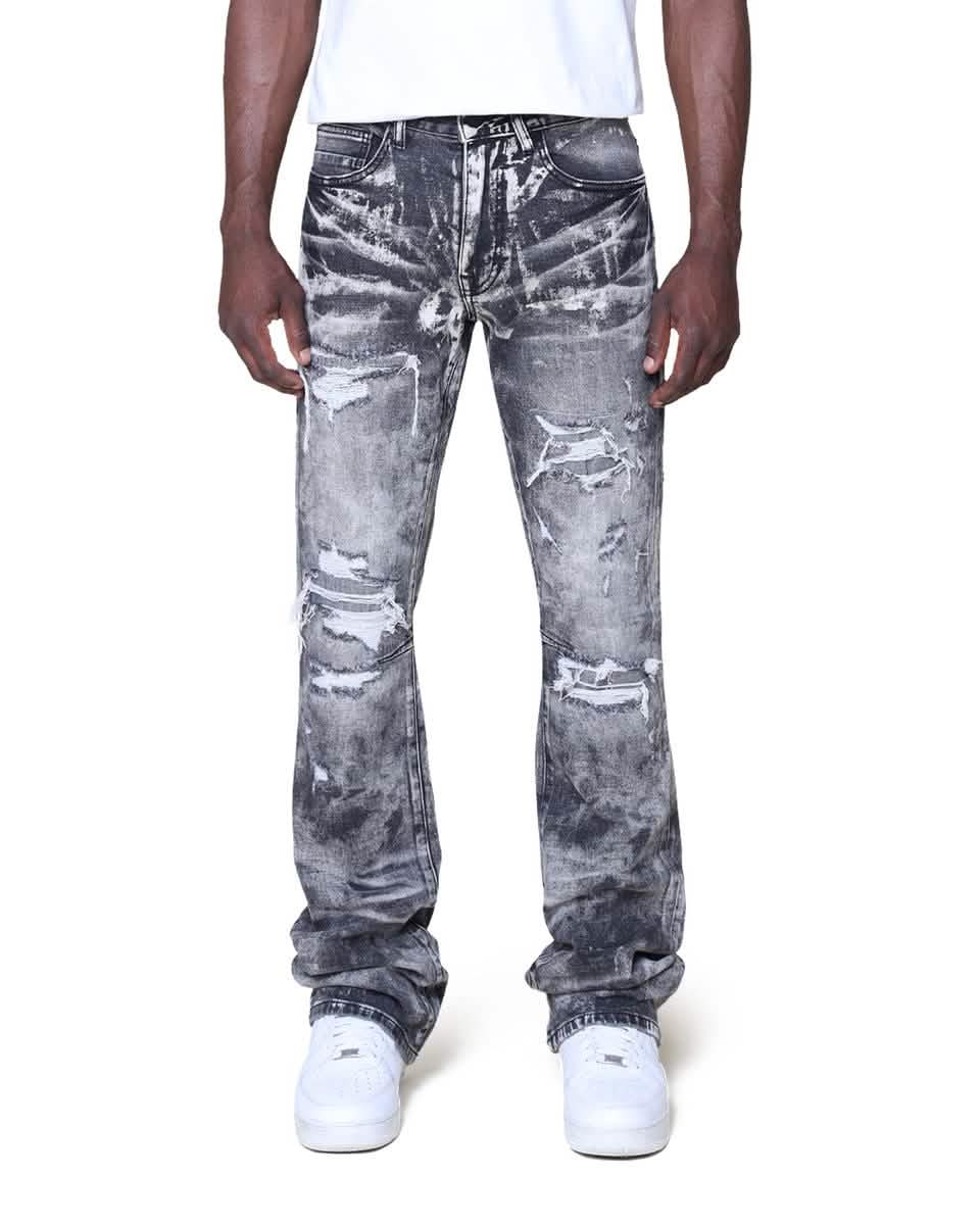 Person wearing distressed gray jeans on a white background
