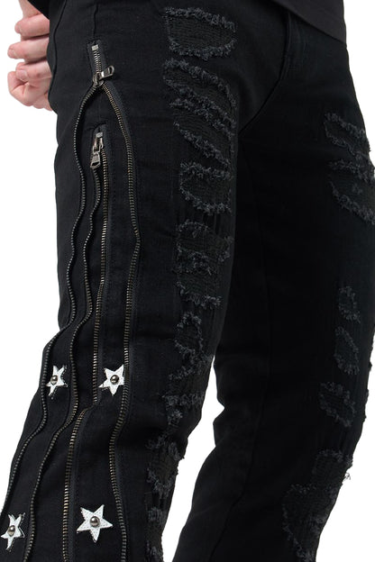 Black pants with zippers and star designs on a white background