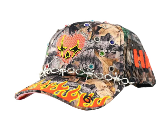 Camouflage cap with colorful designs and embellishments on a white background