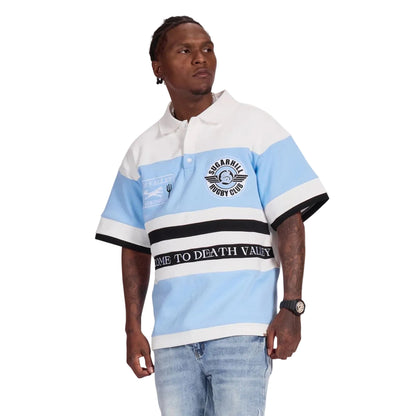 Man wearing a light blue and white striped polo shirt with text on a white background