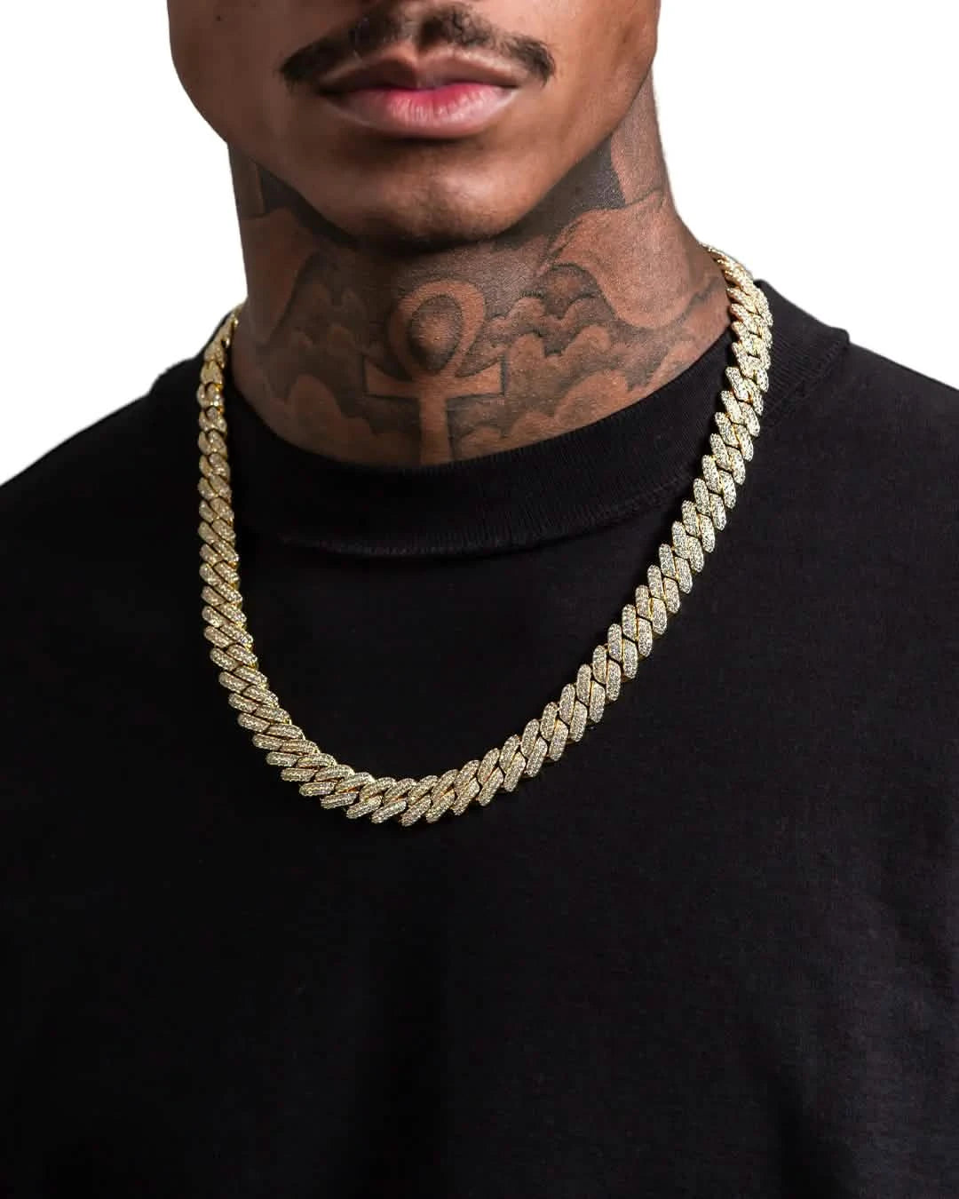 Man wearing a gold chain necklace with a black shirt and tattooed neck.