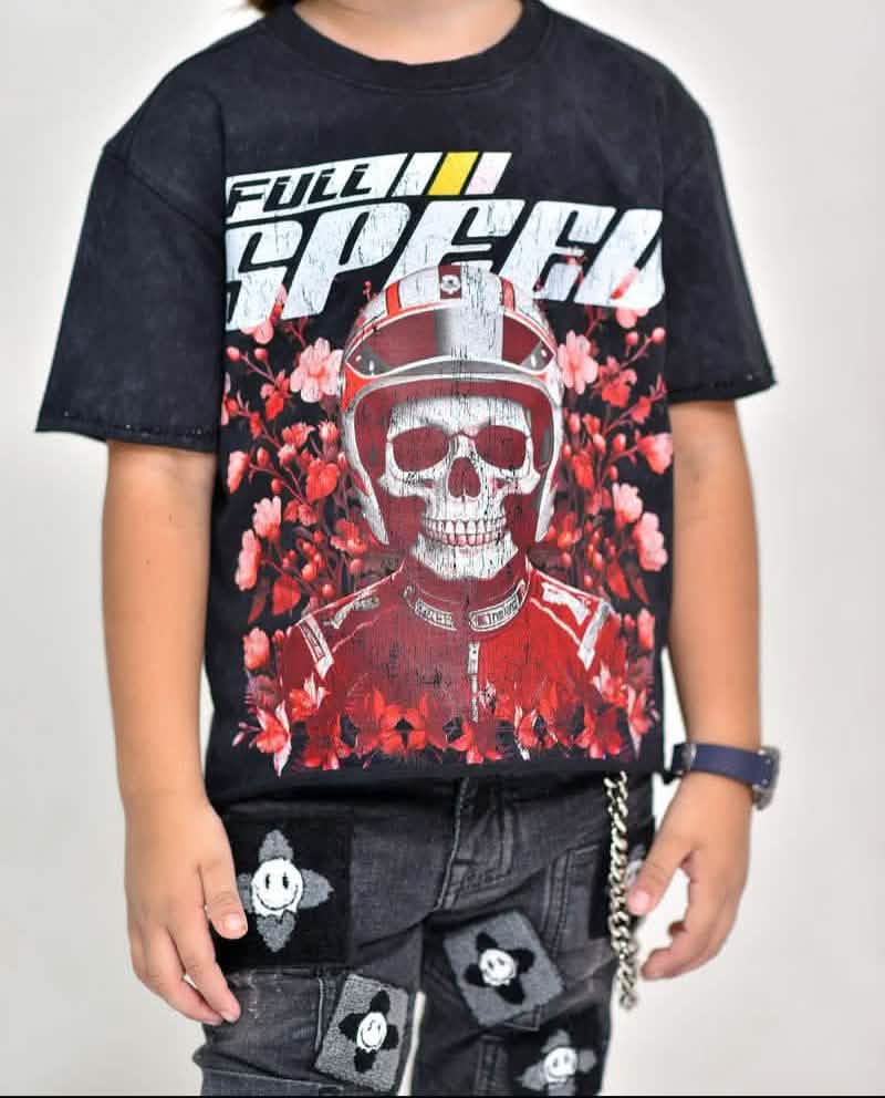 Child wearing a black t-shirt with a graphic design of a skull in a racing helmet and the text 'Full Speed'.