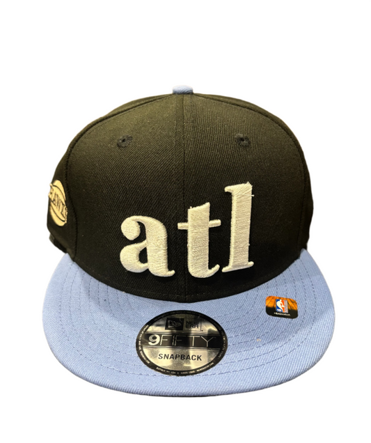 Black and blue cap with 'atl' 