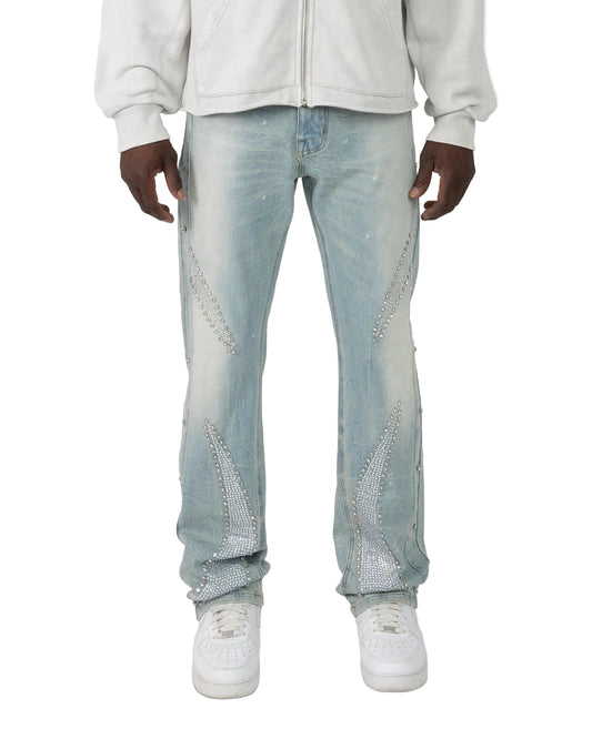 Light blue jeans with rhinestone embellishments worn by a person on a white background