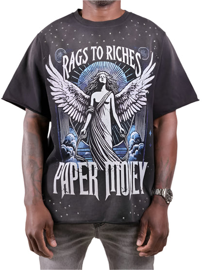 Person wearing a black t-shirt with 'Rags to Riches Paper Tidley' design featuring an angelic figure.