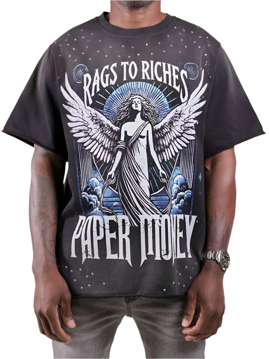 Person wearing a black t-shirt with 'Rags to Riches Paper Tidley' design featuring an angelic figure.