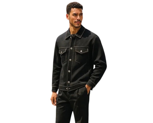 Man wearing a black denim jacket and pants on a white background