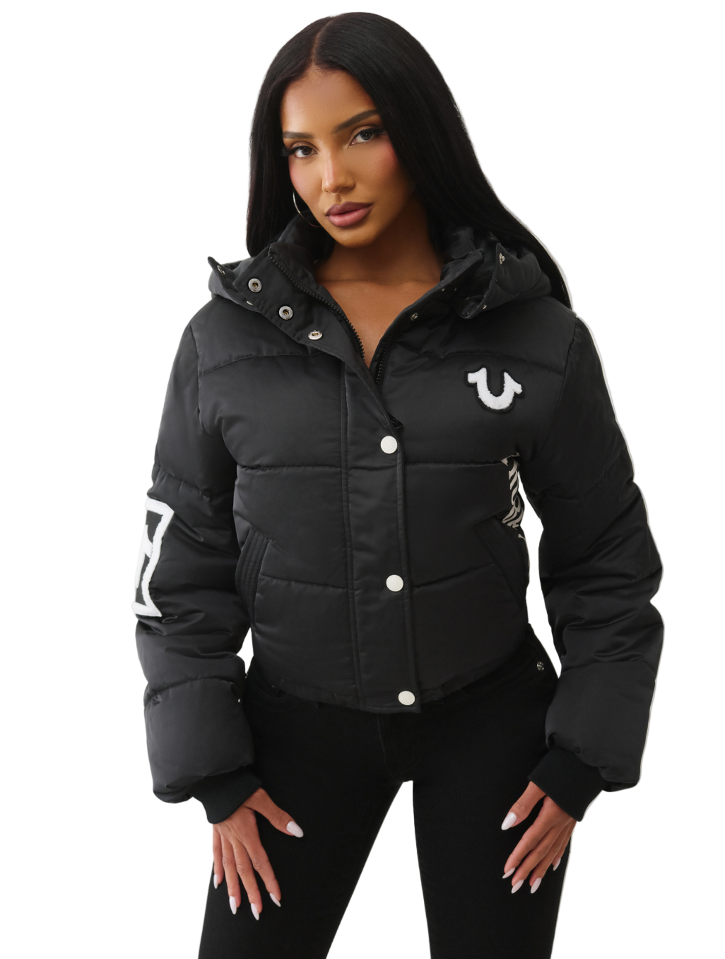 Woman wearing a black puffer jacket with a brand logo on a white background