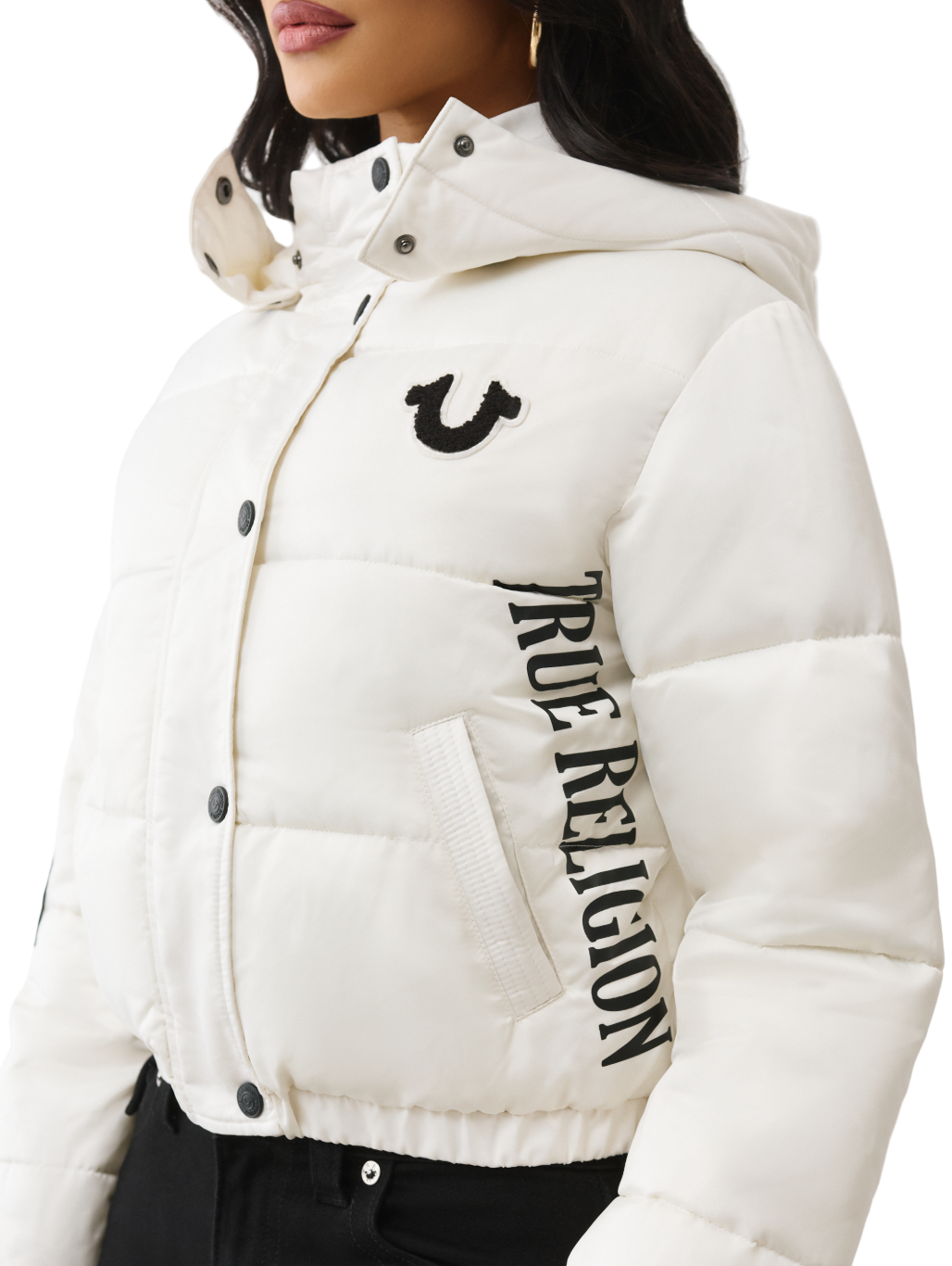 White puffer jacket with 'True Religion' branding on a white background
