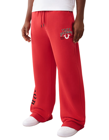 Red sweatpants with a logo and text on a white background