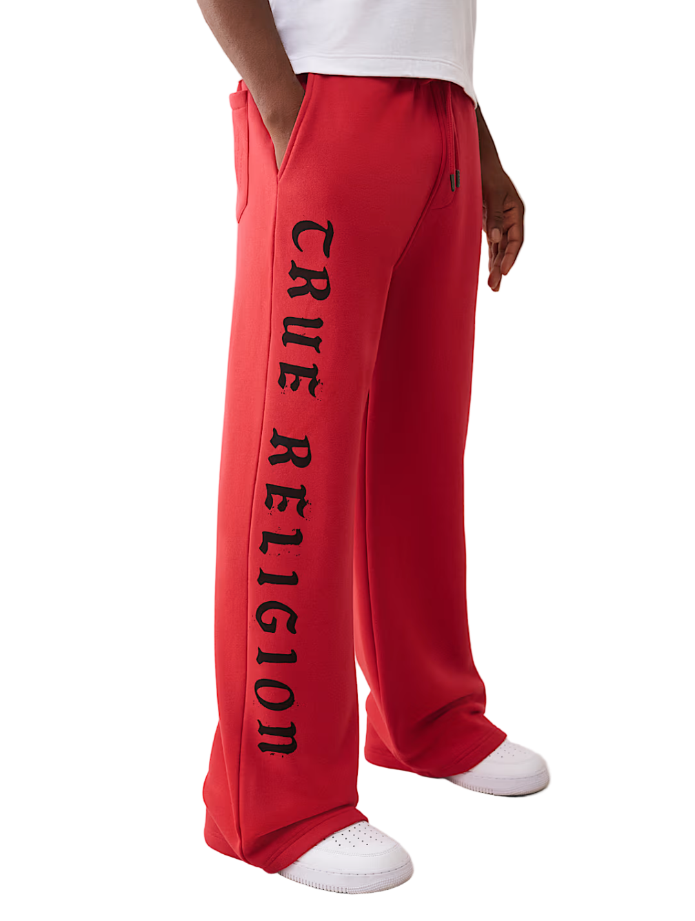Red 'True Religion' sweatpants worn by a person on a white background