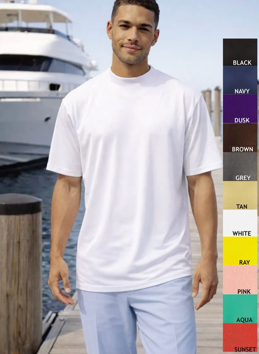Man wearing a white t-shirt with color swatch on a dock with a boat in the background