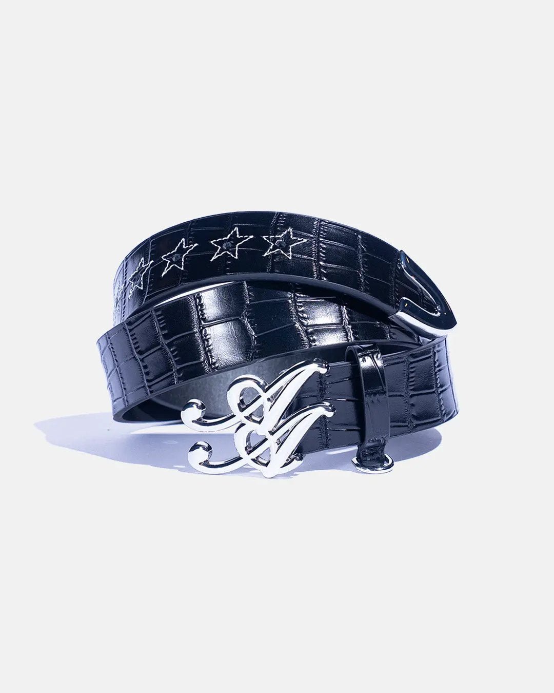 Ad Astra Caiman belt in black, coiled view with monogram buckle