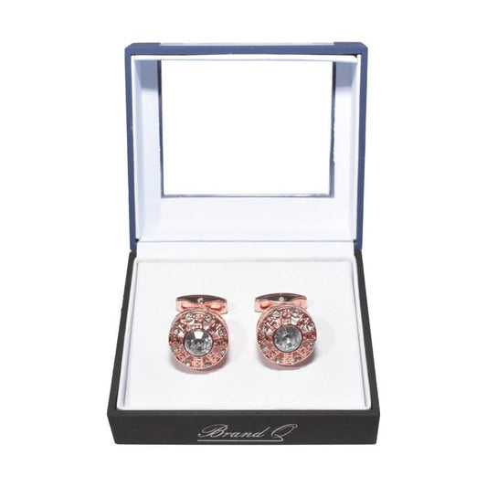 Rose gold cufflinks with gemstones in a branded box on a white background