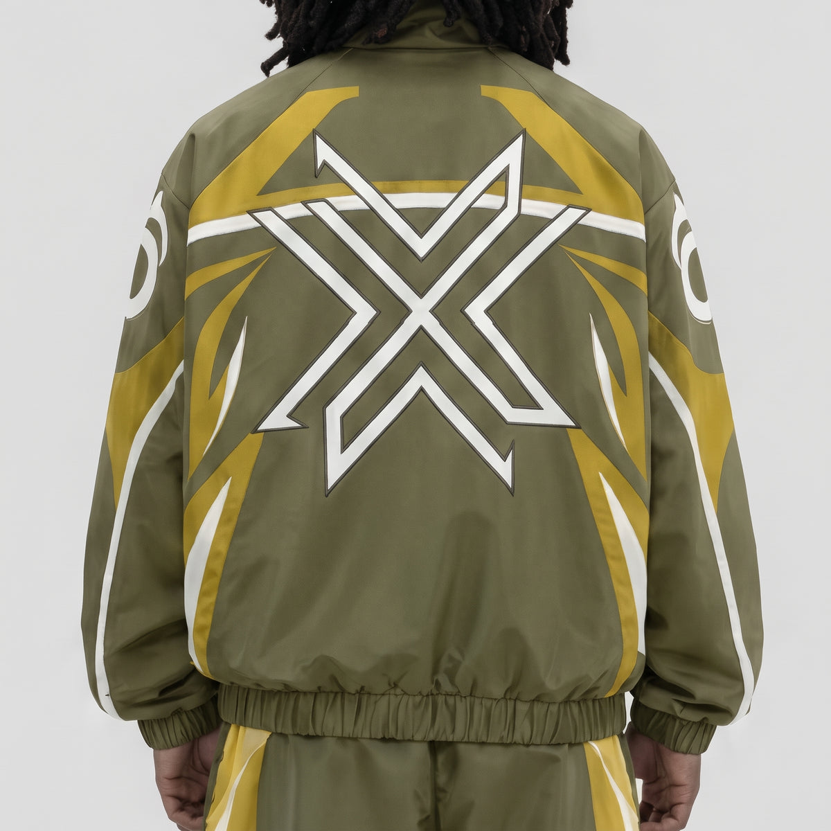 CRXSSCUT Crossfire nylon jacket in olive and yellow with white X graphic, back view on model