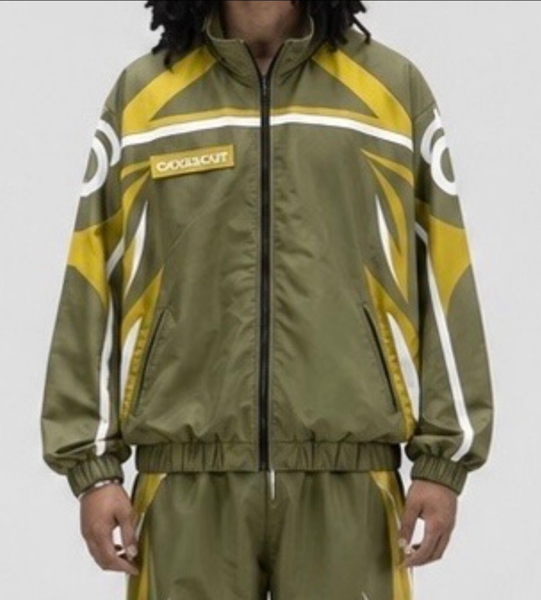 CRXSSCUT Crossfire nylon jacket in olive and yellow with white graphics, front view on model