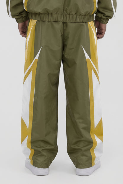 CRXSSCUT Crossfire nylon pants in olive and yellow with white side graphics, back view on model