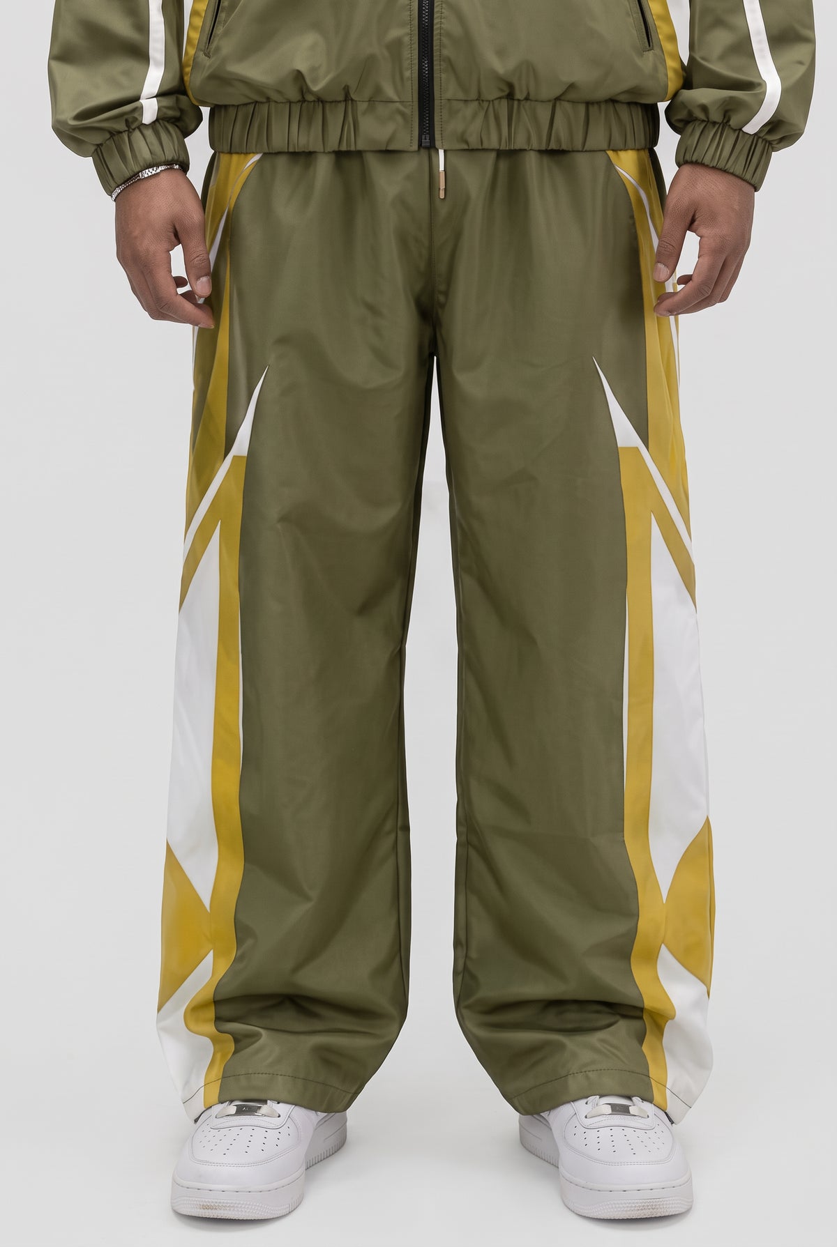 CRXSSCUT Crossfire nylon pants in olive and yellow with white side graphics, front view on model