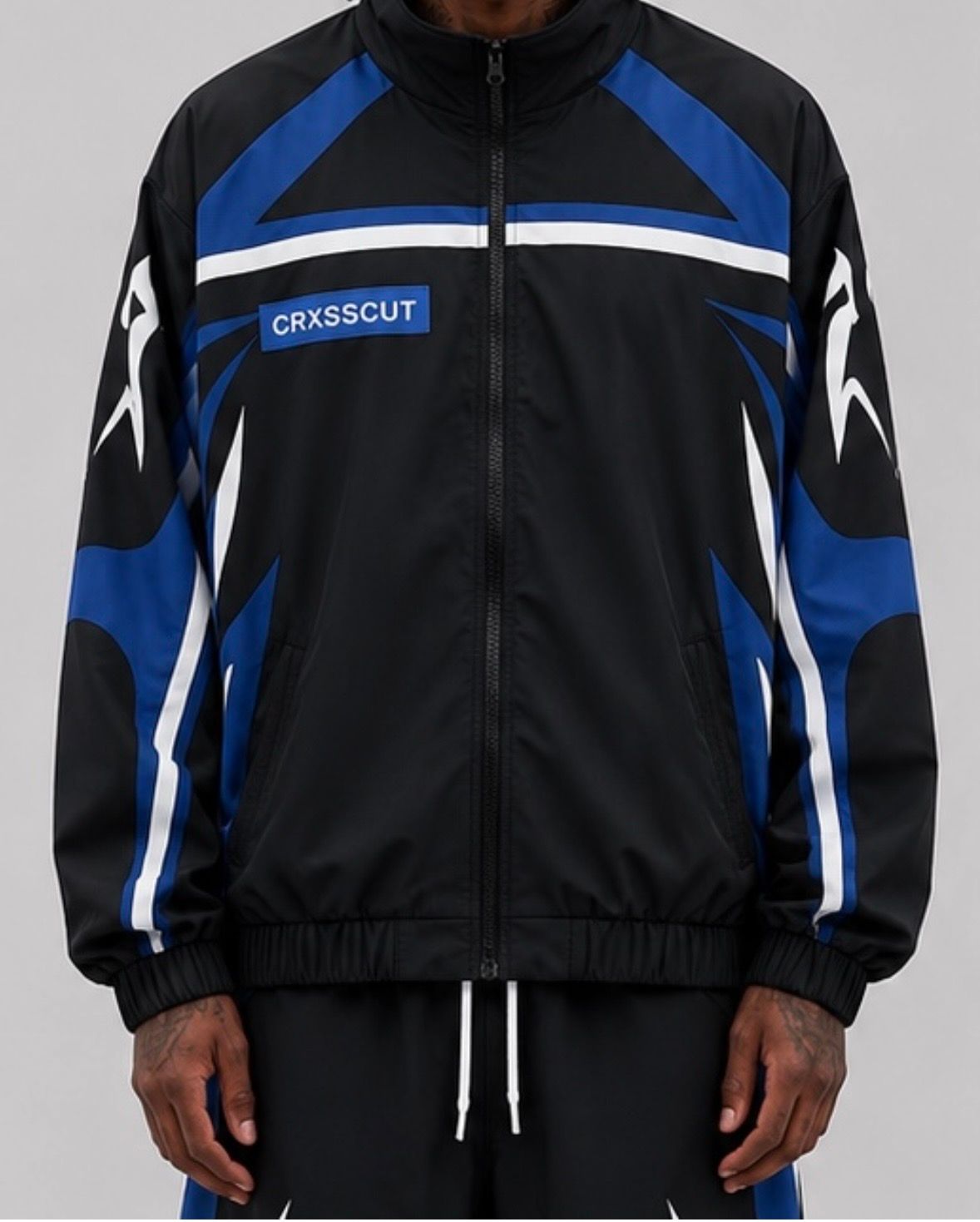 CRXSSCUT Velocity nylon jacket and pants set in black/blue, jacket front view