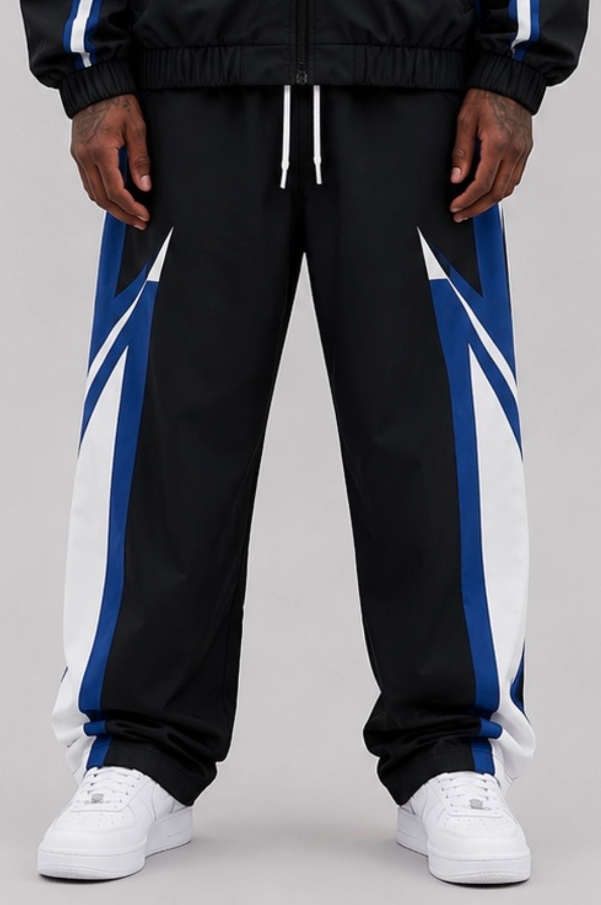 CRXSSCUT Velocity nylon jacket and pants set in black/blue, pants front view