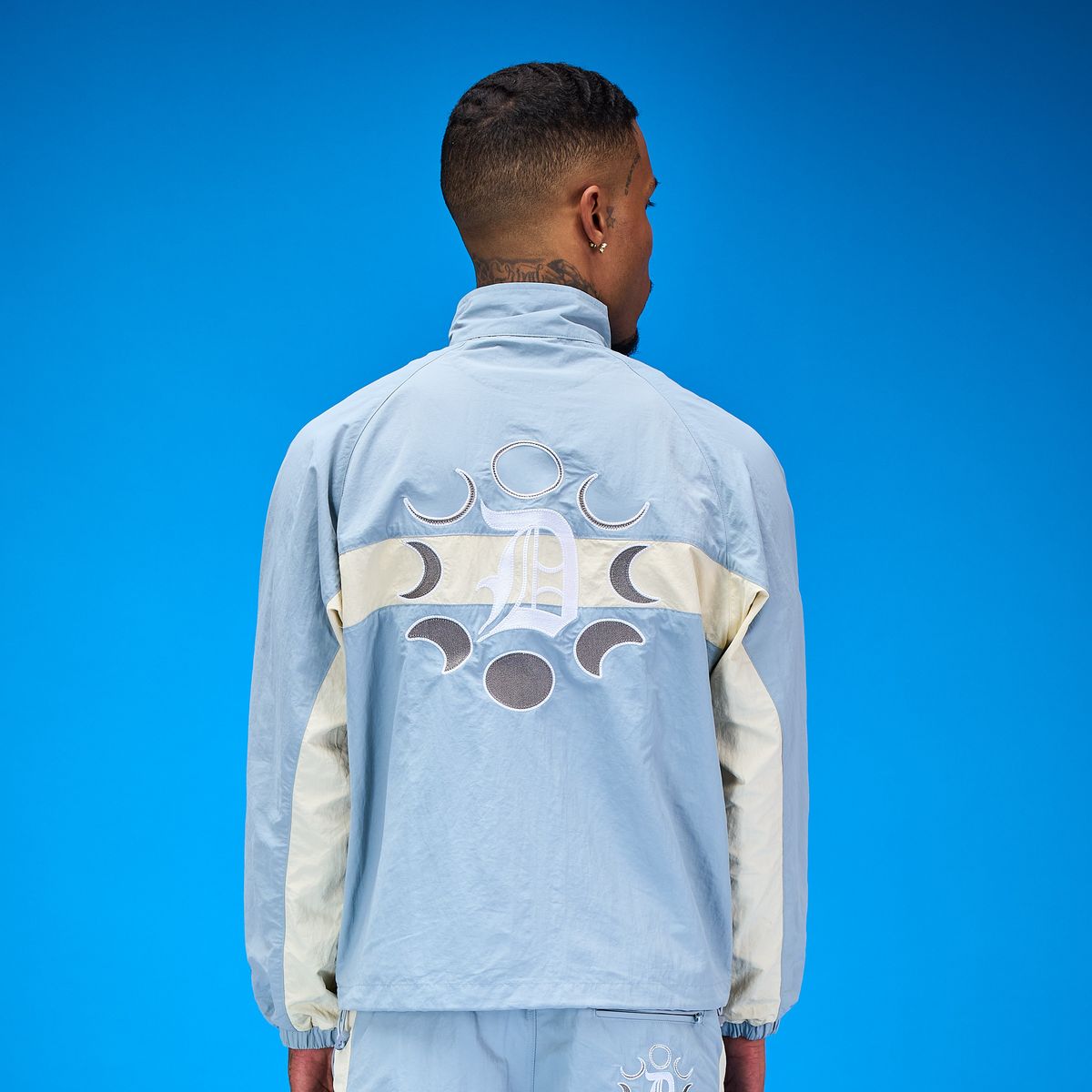 DUAA teal track top back detail