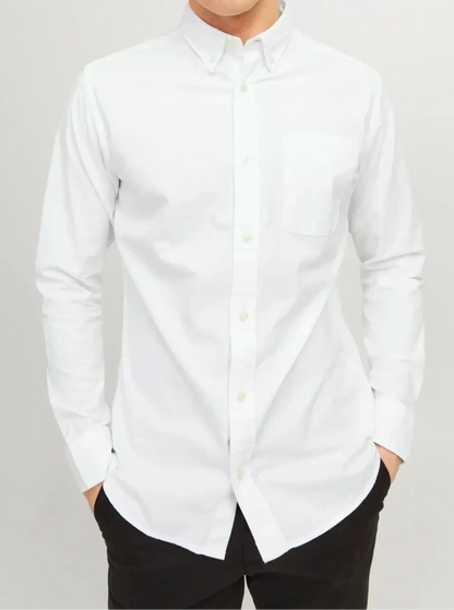 White long-sleeve shirt with a button-down collar and chest pocket, worn with black trousers.