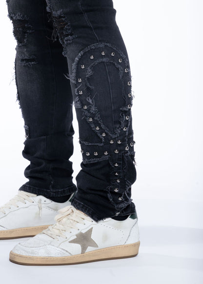 Studded Ankh applique on black denim leg