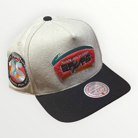Mitchell & Ness San Antonio Spurs Cream Team Pro Snapback from On Time Fashions – Snapback Hat by Mitchell & Ness, Birmingham AL’s 1 fashion store and premier destination for streetwear, suits, kids fashion, and big & tall