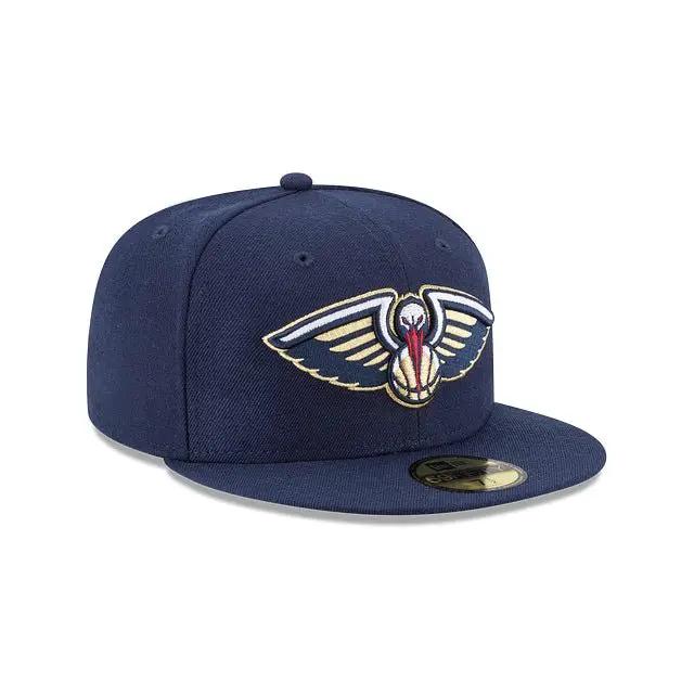 Angled front view of navy New Era 59Fifty New Orleans Pelicans cap with navy visor and team logo.