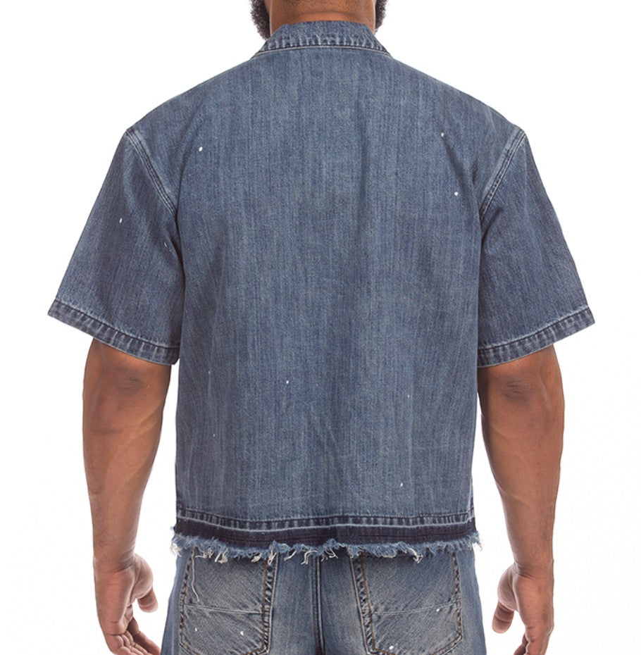 On Time Fashions Akoo SS Woven denim shirt with paint splatter and frayed hem. Short sleeve, wide body fit.