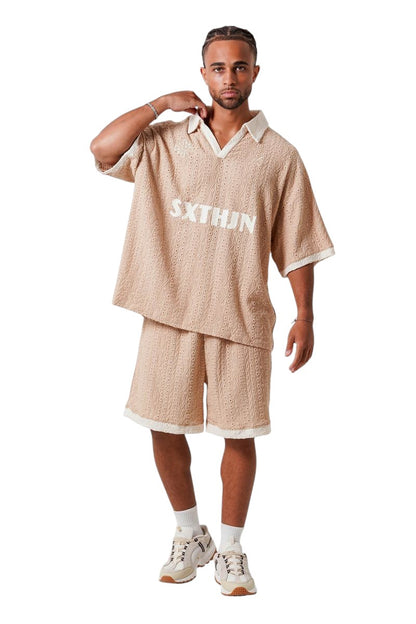 On Time Fashions men's beige crochet resort set with embroidered logo on tee and shorts. Relaxed fit.
