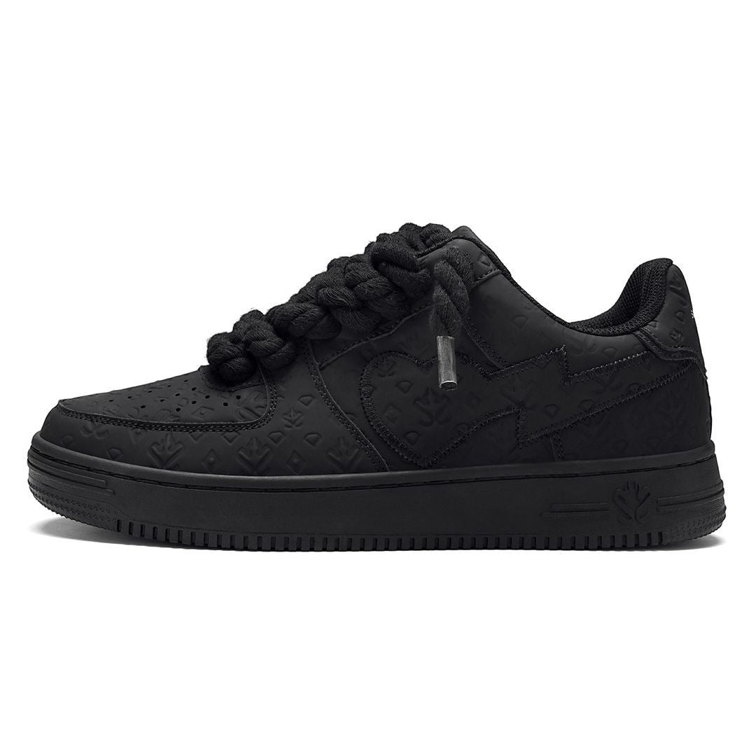 On Time Fashions black chunky sneakers with thick braided laces and embossed logo pattern.