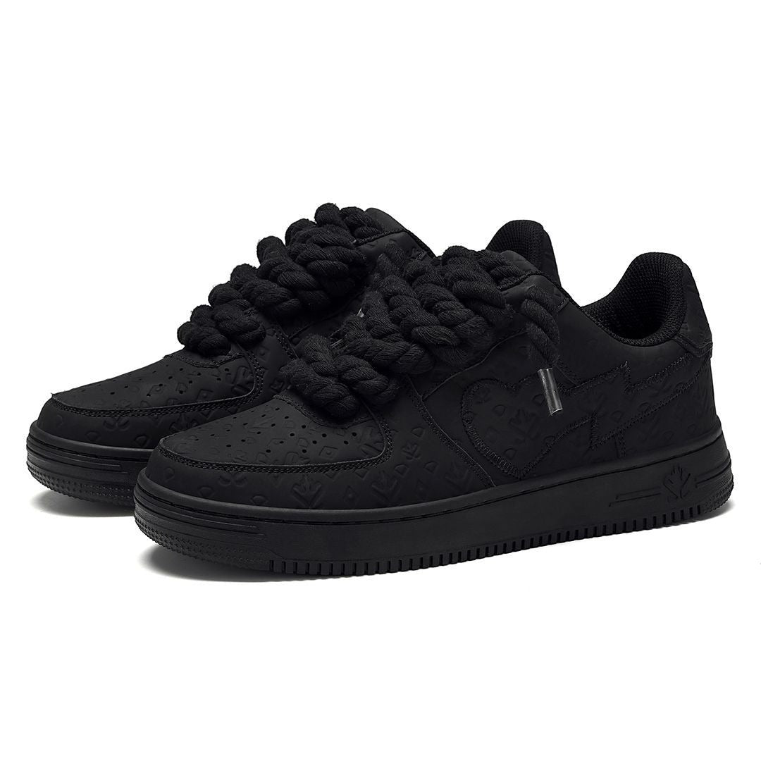 On Time Fashions black chunky sneakers with rope laces and embossed logo pattern.