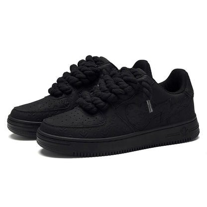 On Time Fashions black chunky sneakers with rope laces and embossed logo pattern.