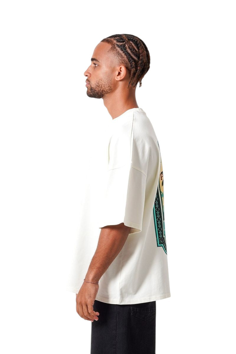 On Time Fashions cream oversized cotton tee with vibrant Caribbean beach print on back. Relaxed fit, short sleeves.