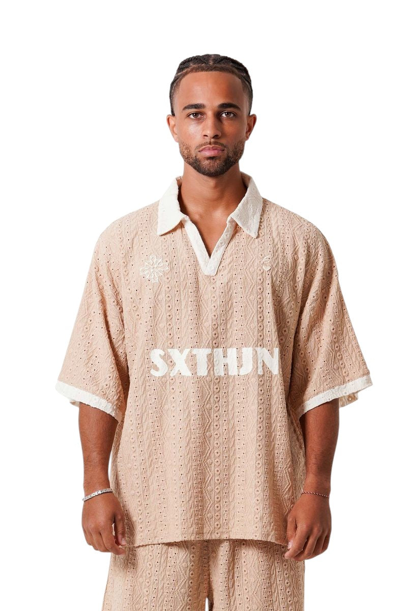 On Time Fashions beige crochet resort set with embroidered logo on tee and shorts. Relaxed fit, short sleeves, polo collar.