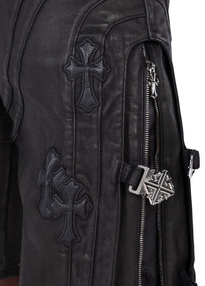 On Time Fashions Guapi all black denim shorts featuring cross appliqué, side zip pockets, and metal buckle hardware.