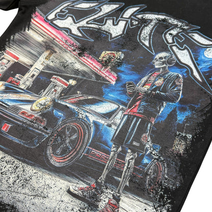 On Time Fashions kids black cotton tee featuring a detailed graphic of a skeleton by a sports car at a gas station