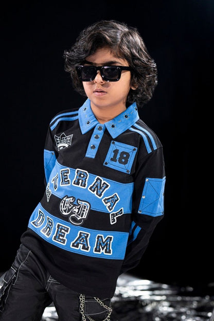 On Time Fashions black and blue long-sleeve polo shirt for kids with rhinestone details and "Eternal Dream" graphic.