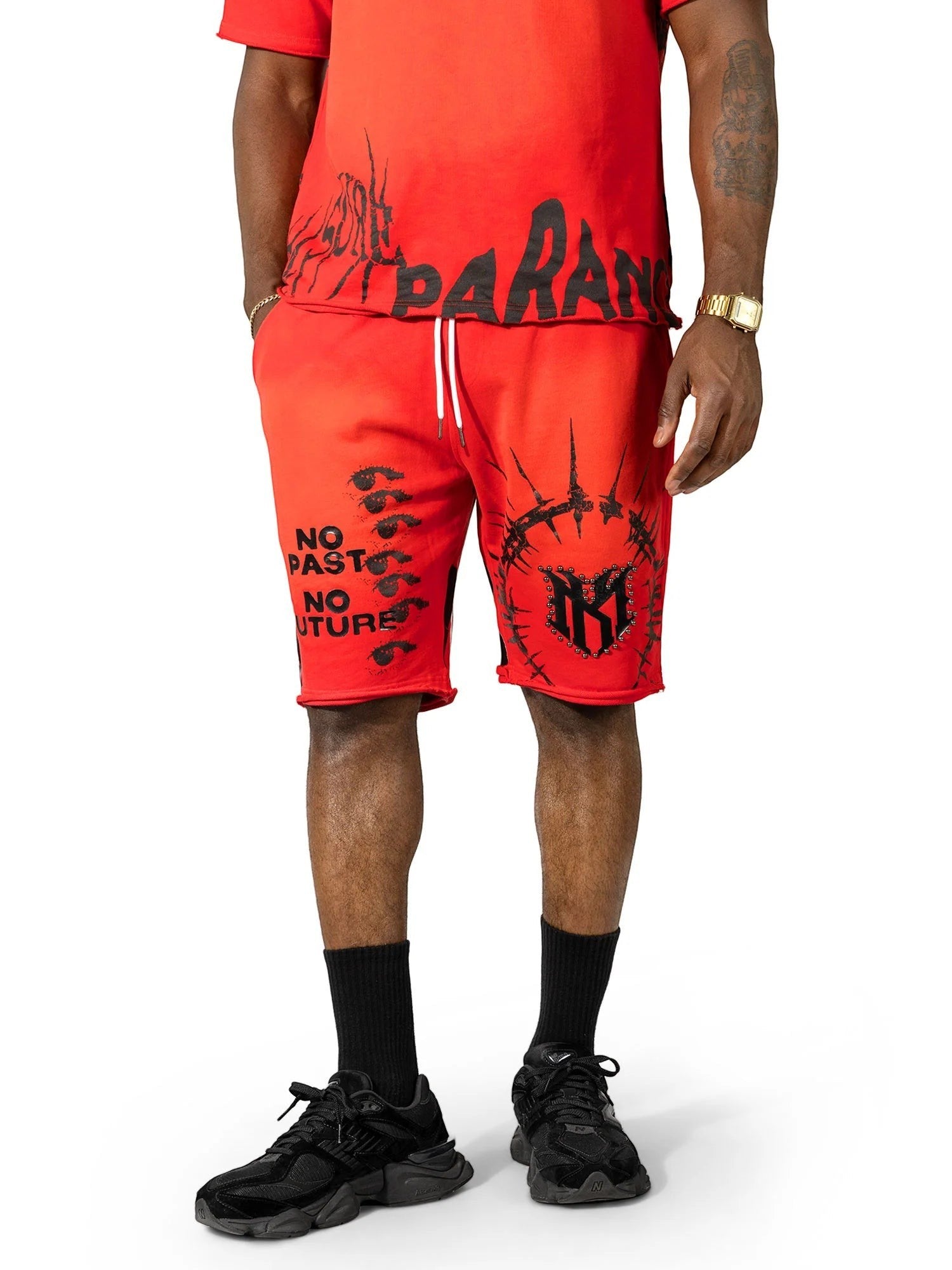 On Time Fashions Makobi Paranova red streetwear short set with black graphic print and raw hem detail on a model.