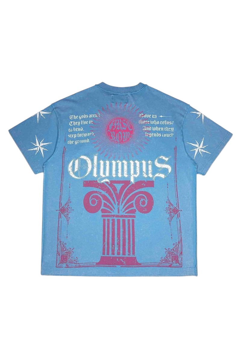 On Time Fashions blue washed graphic tee featuring Olympus column print, text, and star motifs in pink and white.