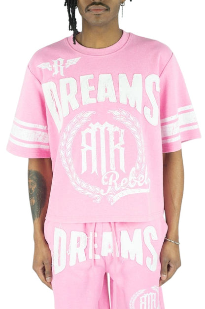 On Time Fashions pink jersey with white 'DREAMS' lettering and laurel wreath graphic. Short sleeves with white stripes.