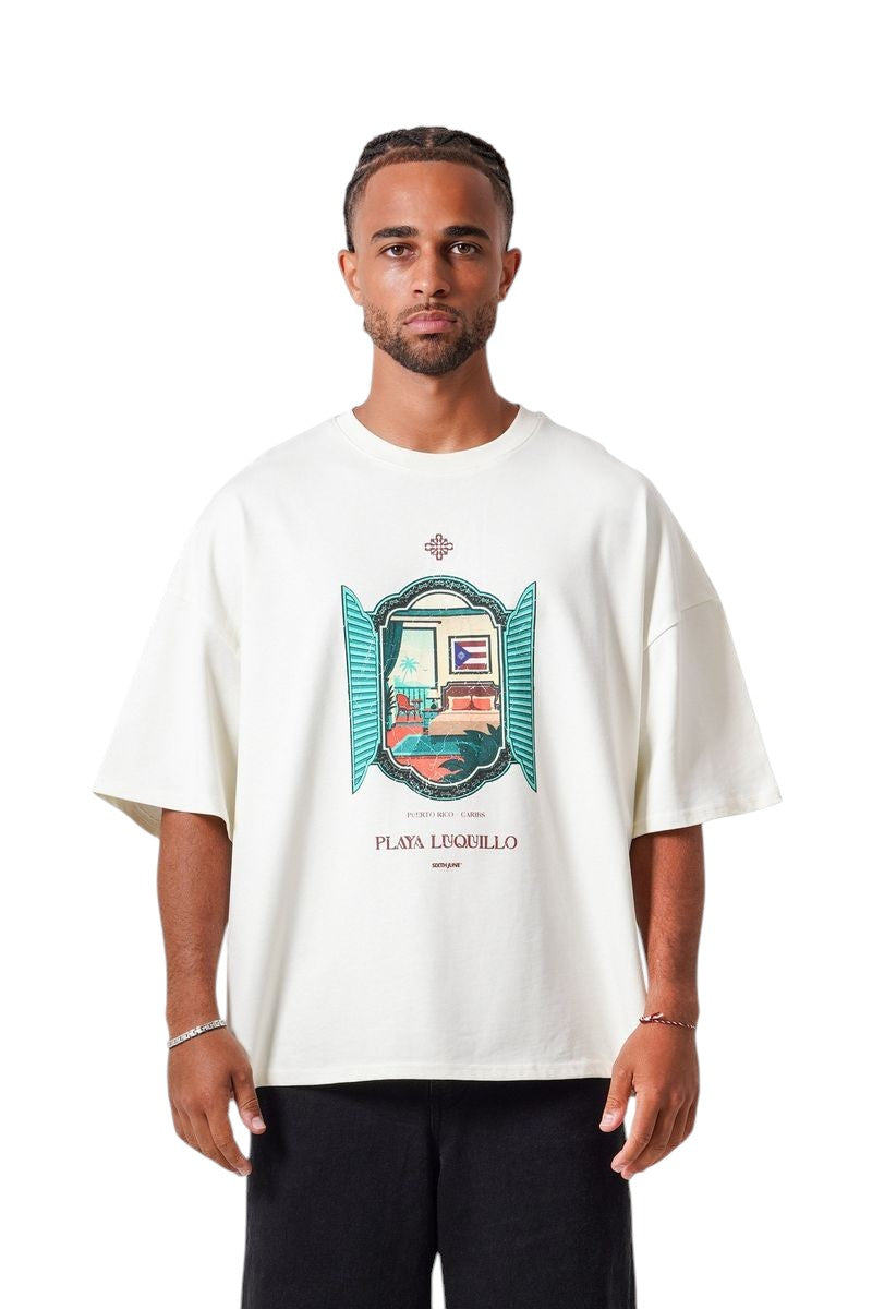 On Time Fashions cream oversized cotton tee with a graphic print of a room with a view of Puerto Rico and the text Playa Luquillo.