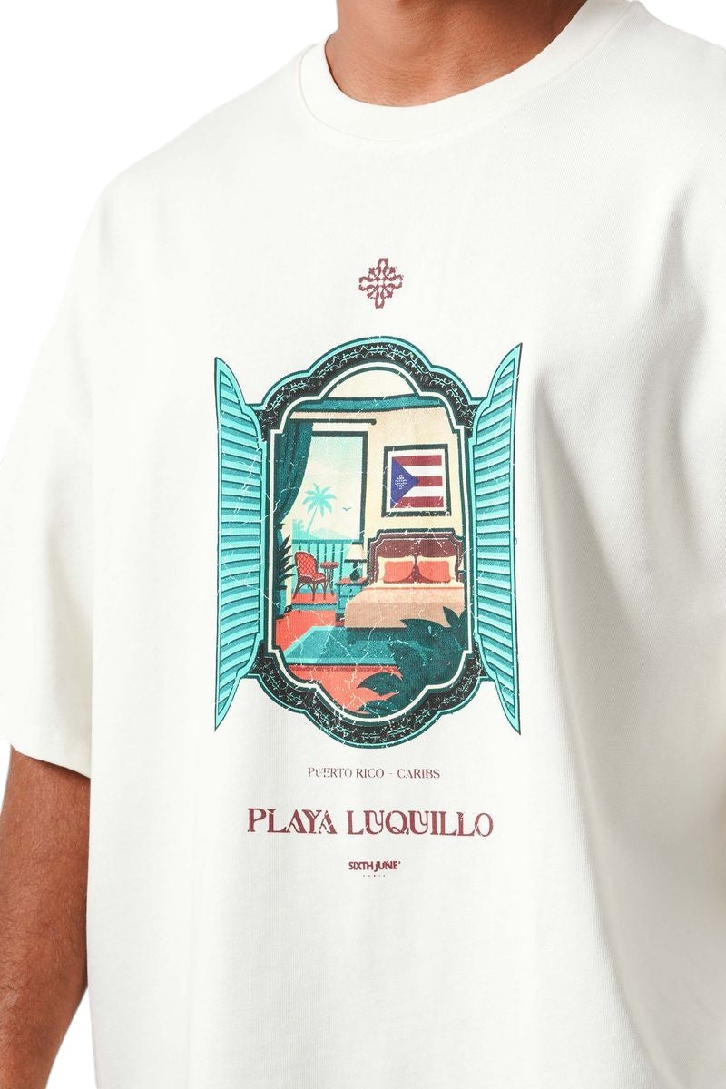 On Time Fashions cream cotton tee with oversized boxy fit, featuring a graphic print of a tropical bedroom view through an open window.