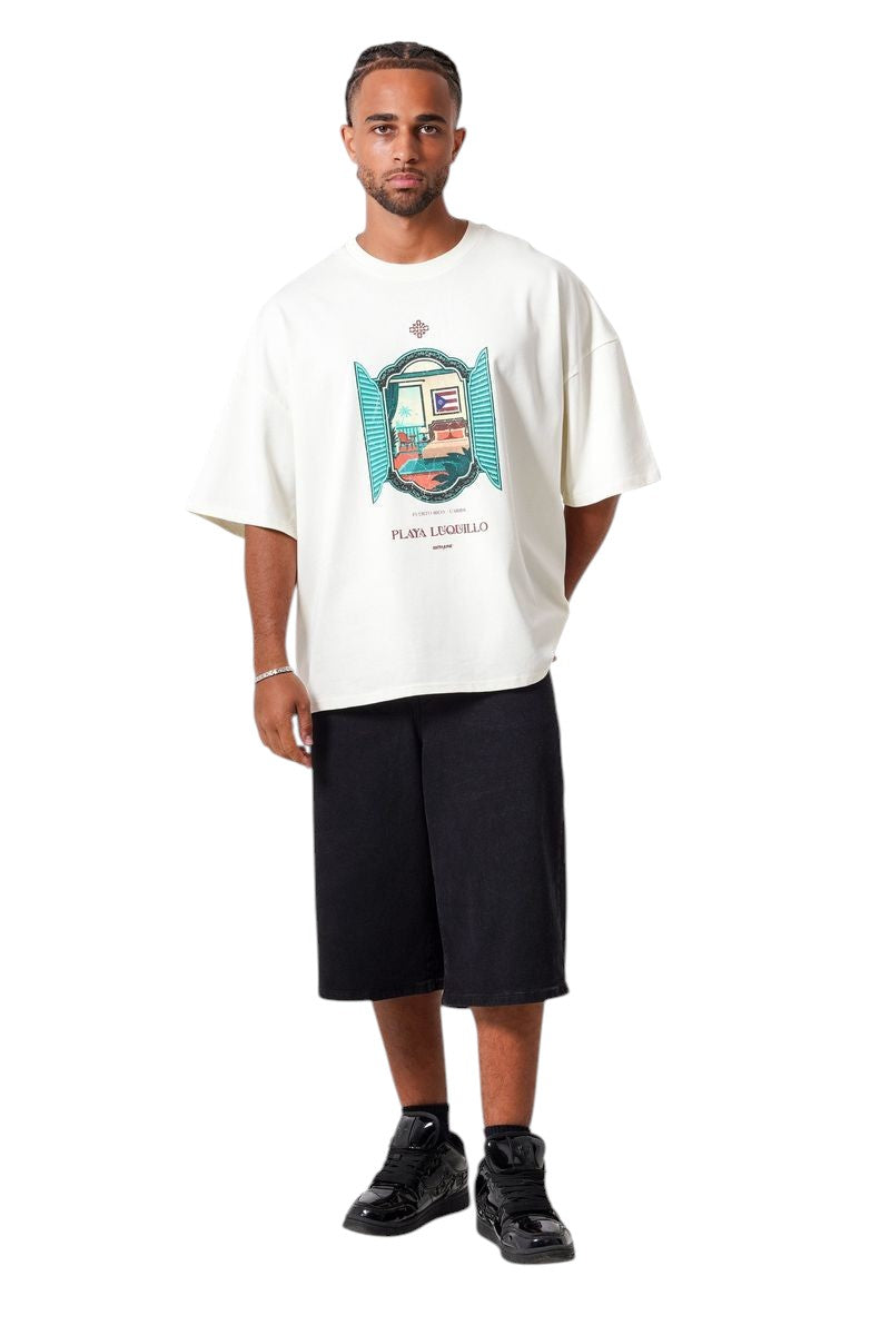 On Time Fashions cream oversized cotton t-shirt with a graphic print of a window view of a tropical beach scene and the text "Playa Luquillo".