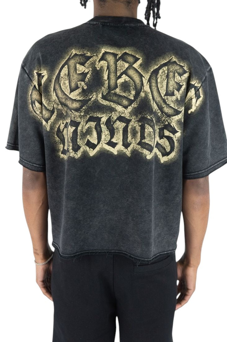On Time Fashions heavyweight black acid-wash tee with Rebel Minds graphic in distressed gold lettering on the back.