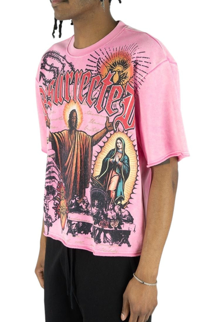 On Time Fashions pink heavyweight French terry tee featuring a graphic Jesus Relic print and raw hem detail.